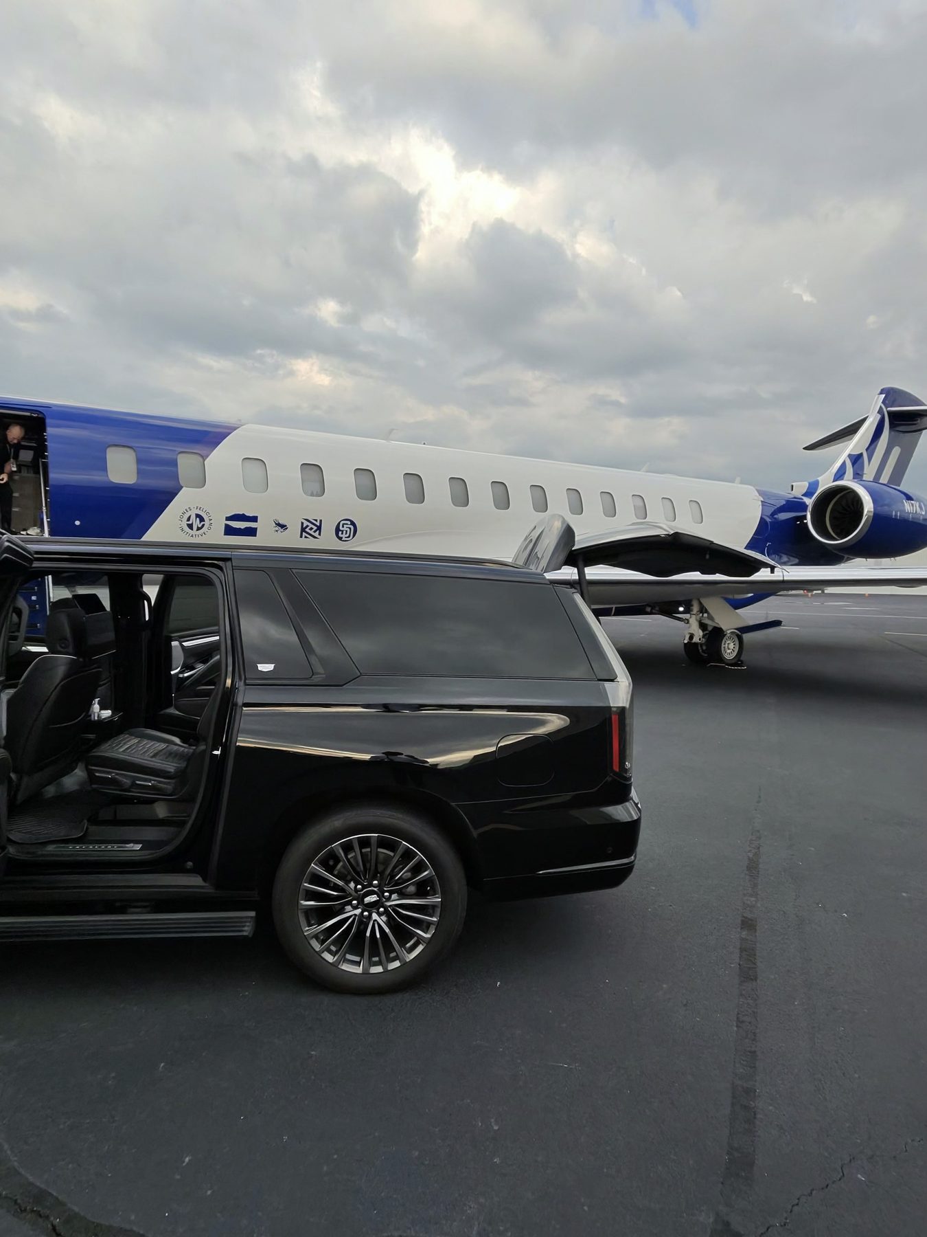 Black SUV beside a private jet on the tarmac