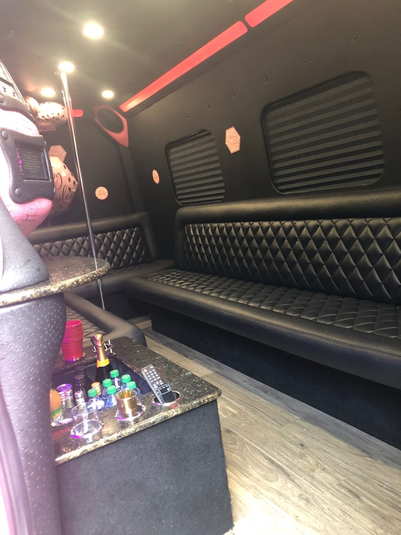 Lounge seating and refreshments inside a passenger van