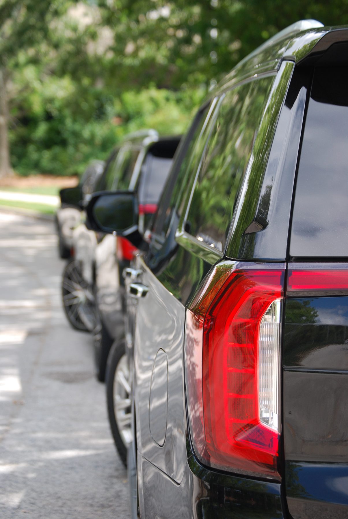 Close-up of black SUVs lined up outdoors