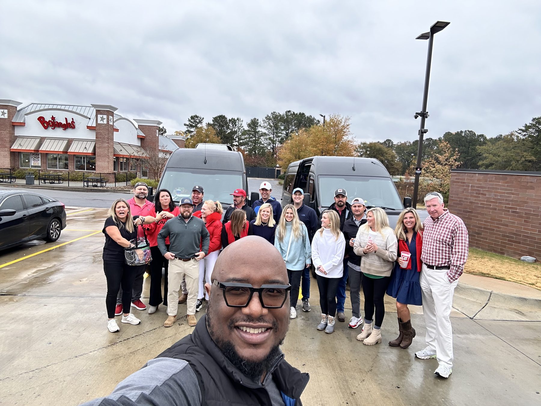 Group photo with the chauffeur and passenger vans