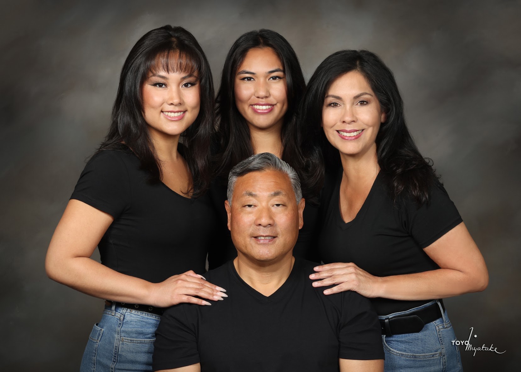 Eric with his family in a studio portrait