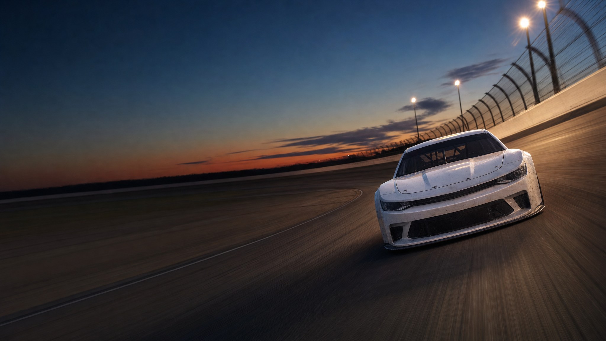 An unbranded stock car racing under track lights at dusk