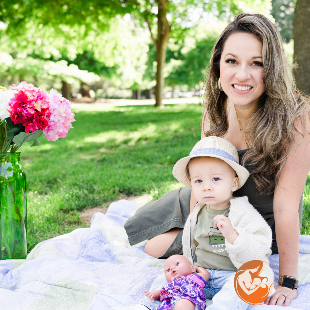 Parent sitting outdoors with a young child during a calm family moment