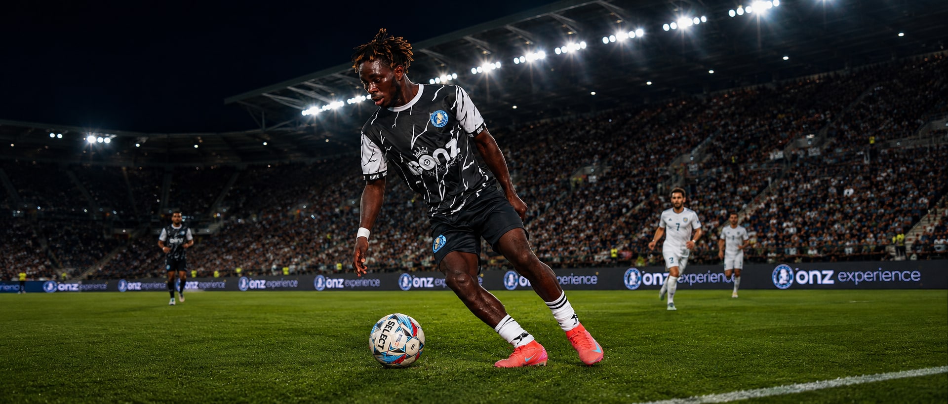 Brooke House FC player carrying the ball during an evening match