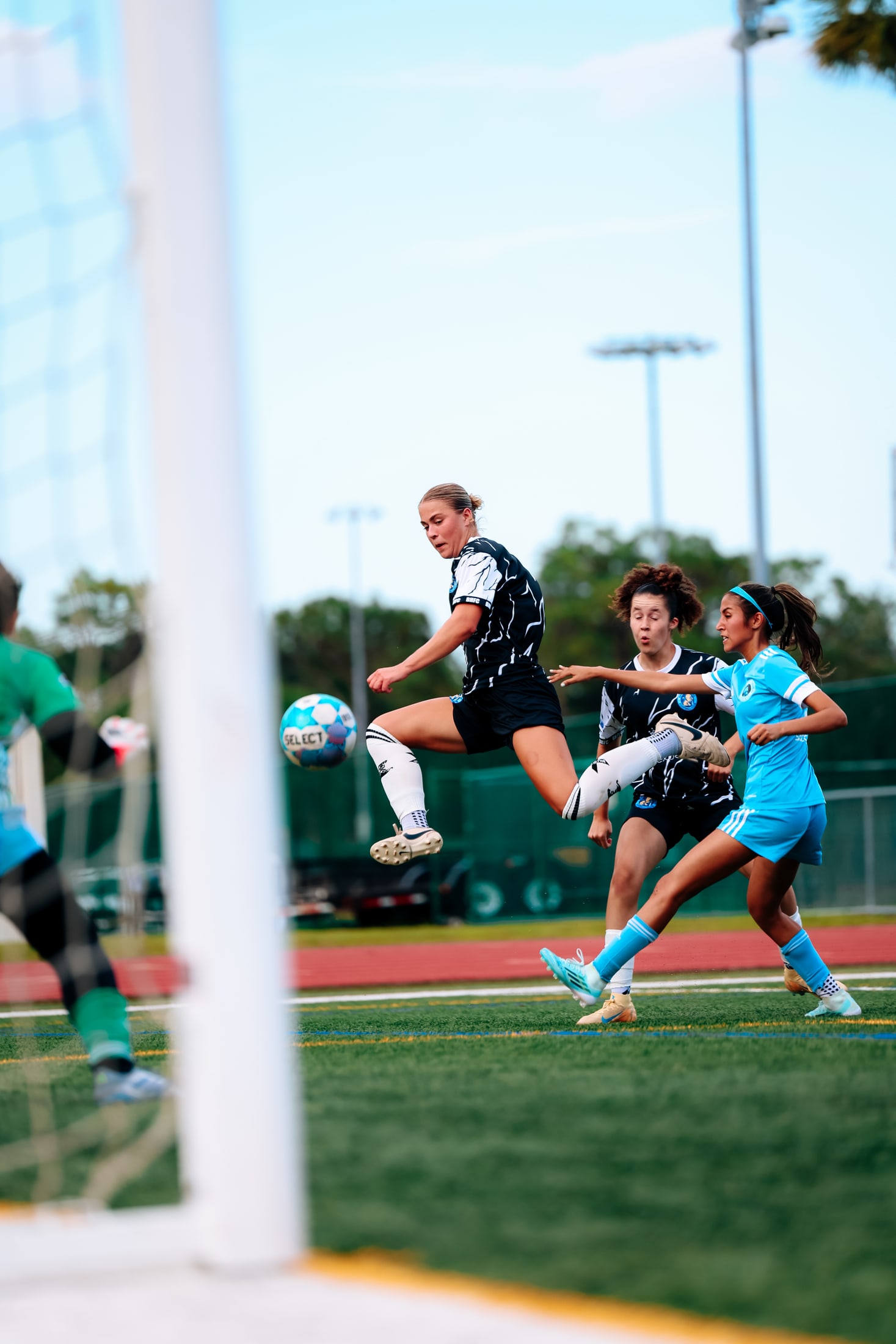 Two soccer players competing for possession during a match