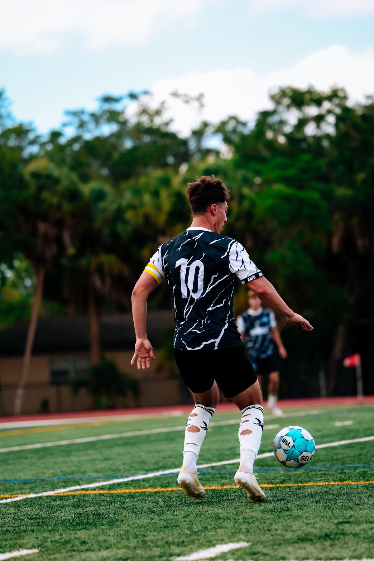 Brooke House FC men's player competing in match action