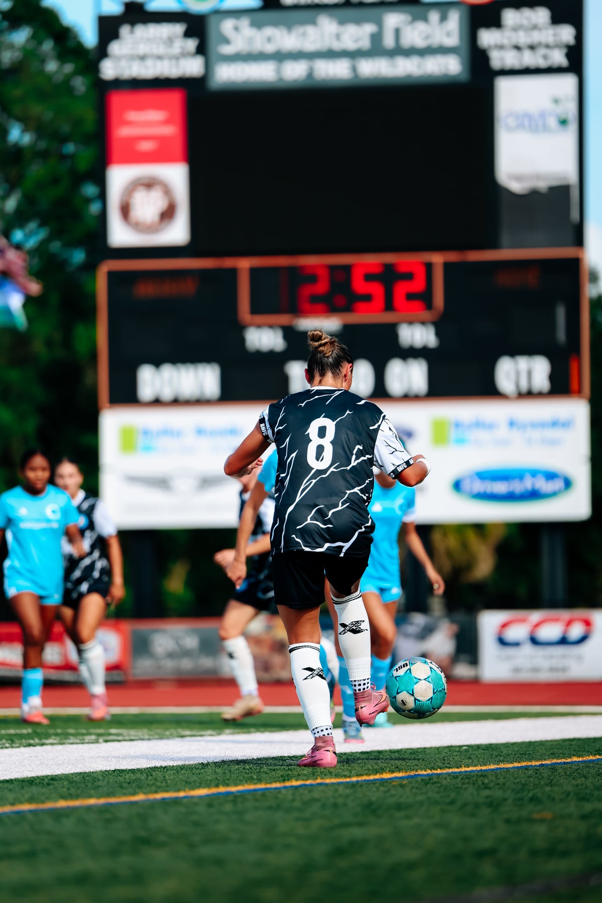 Soccer player competing for the ball in a Brooke House FC match