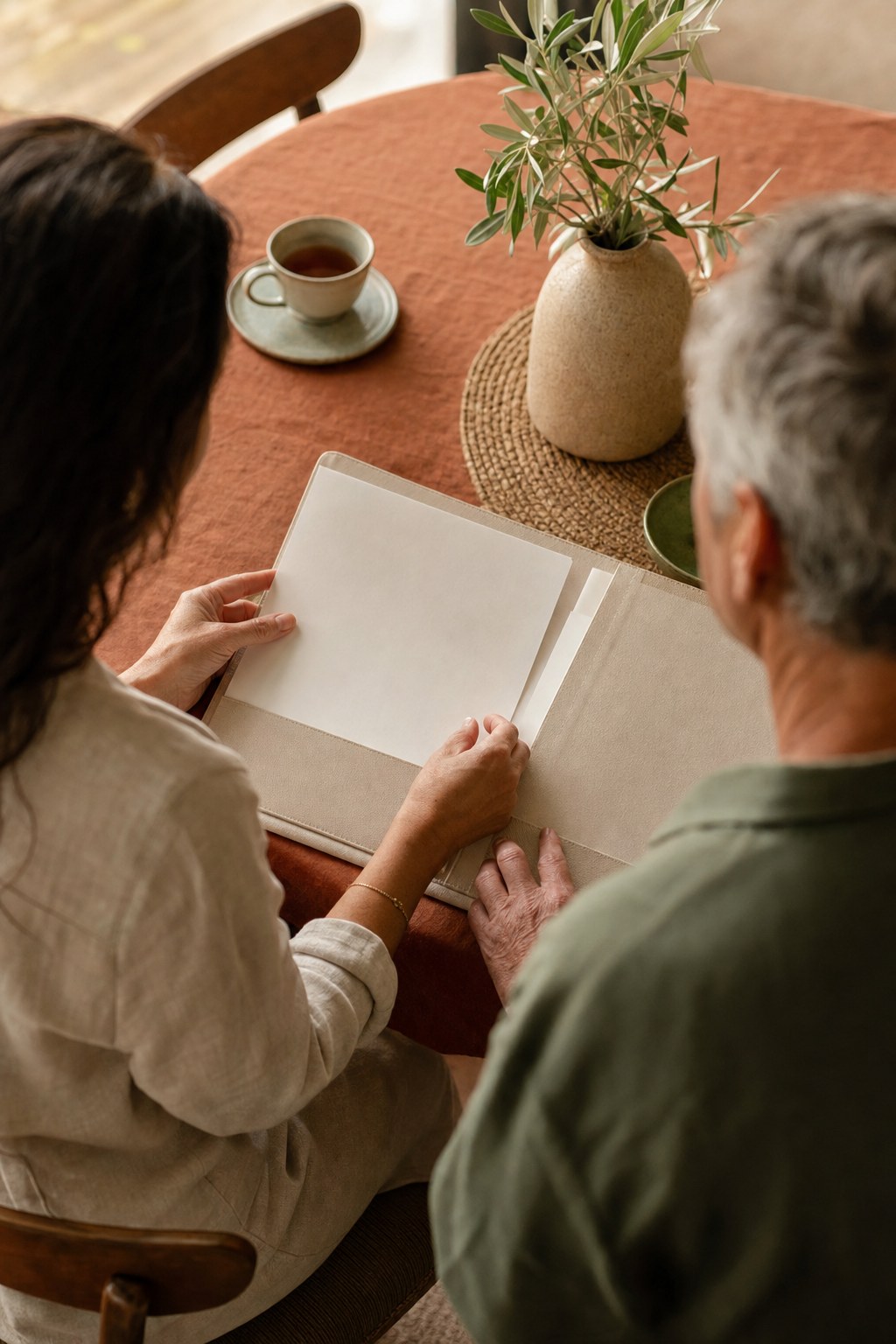 Family members quietly organizing papers at a table