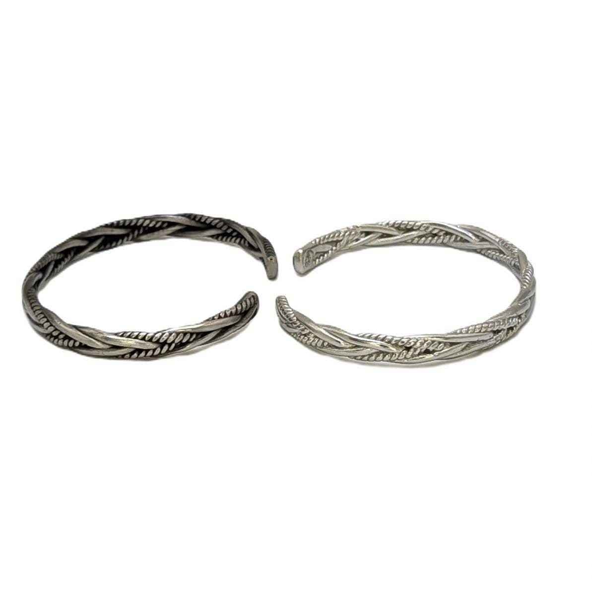 Two hand-cast pewter cuff bracelets with braided detail