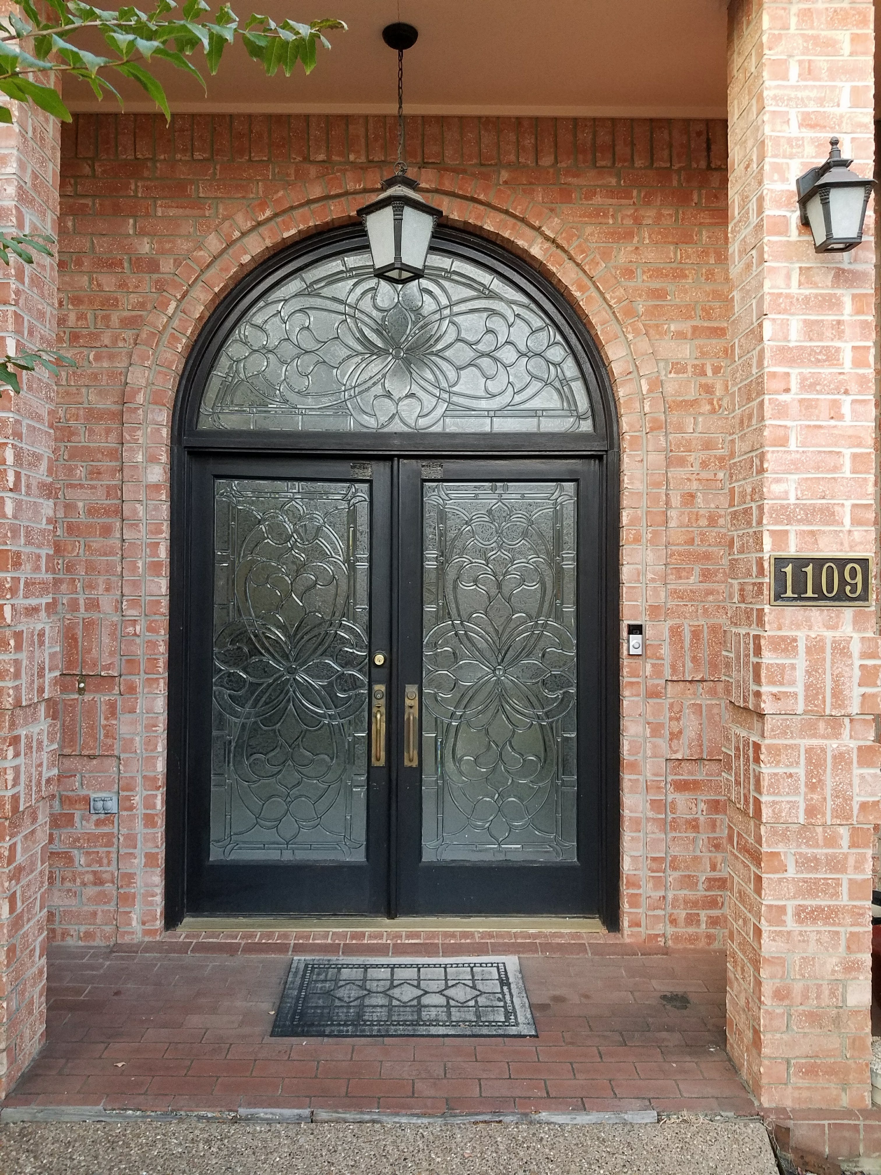 Finished arched black double entry doors