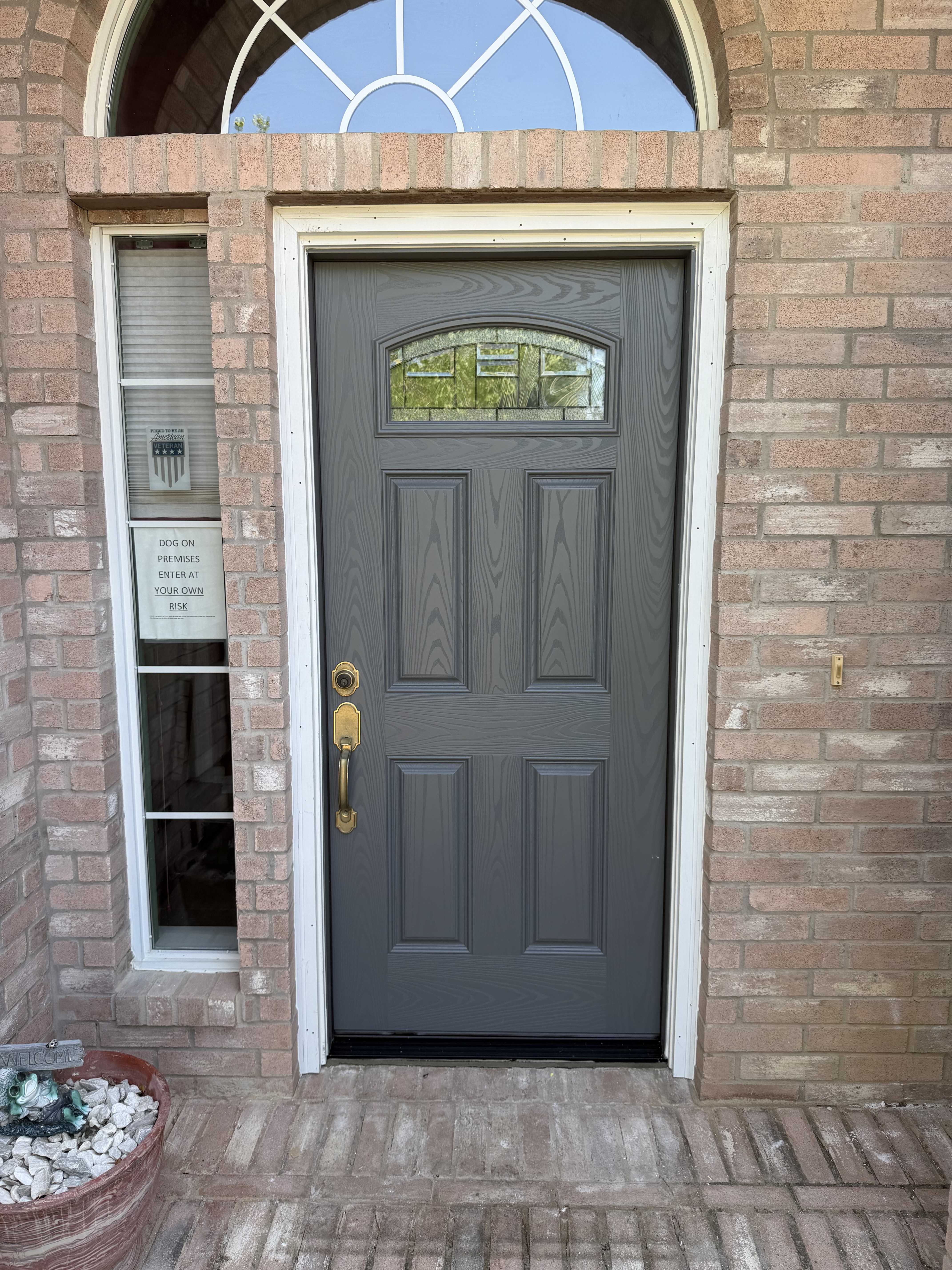 Finished charcoal gray front door with oval glass