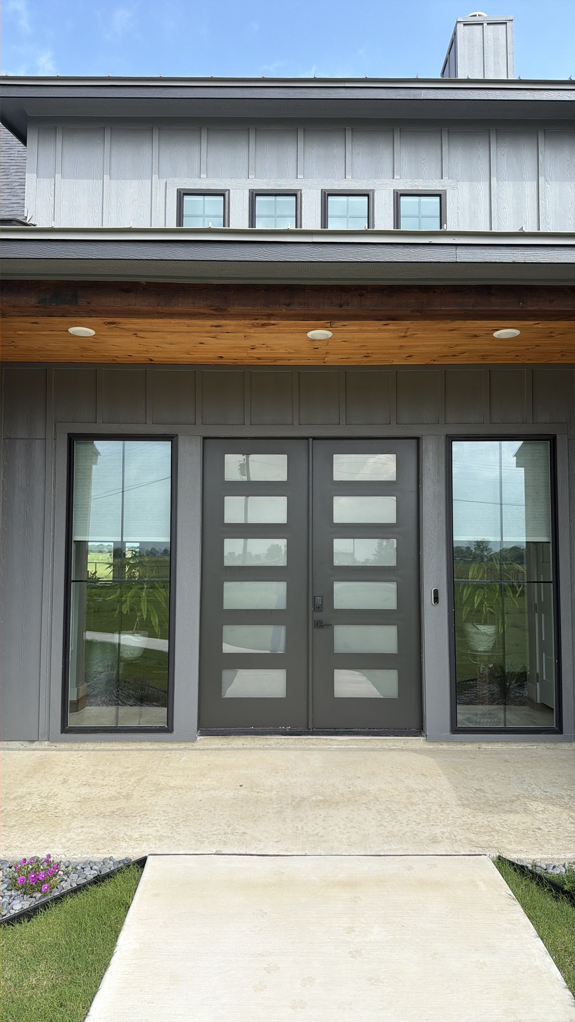 Modern dark gray front door with glass panels