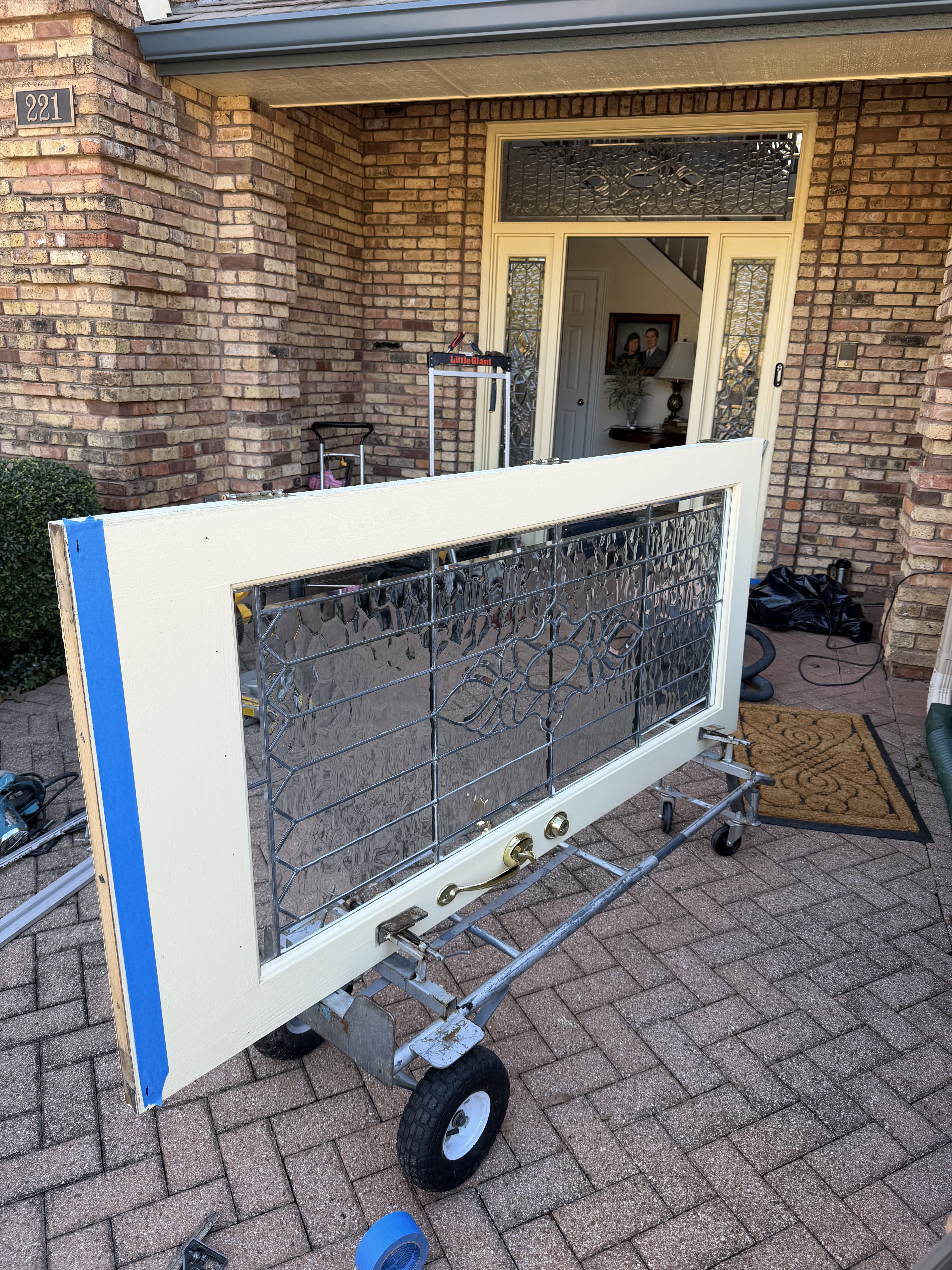 New white screen door at a brick home