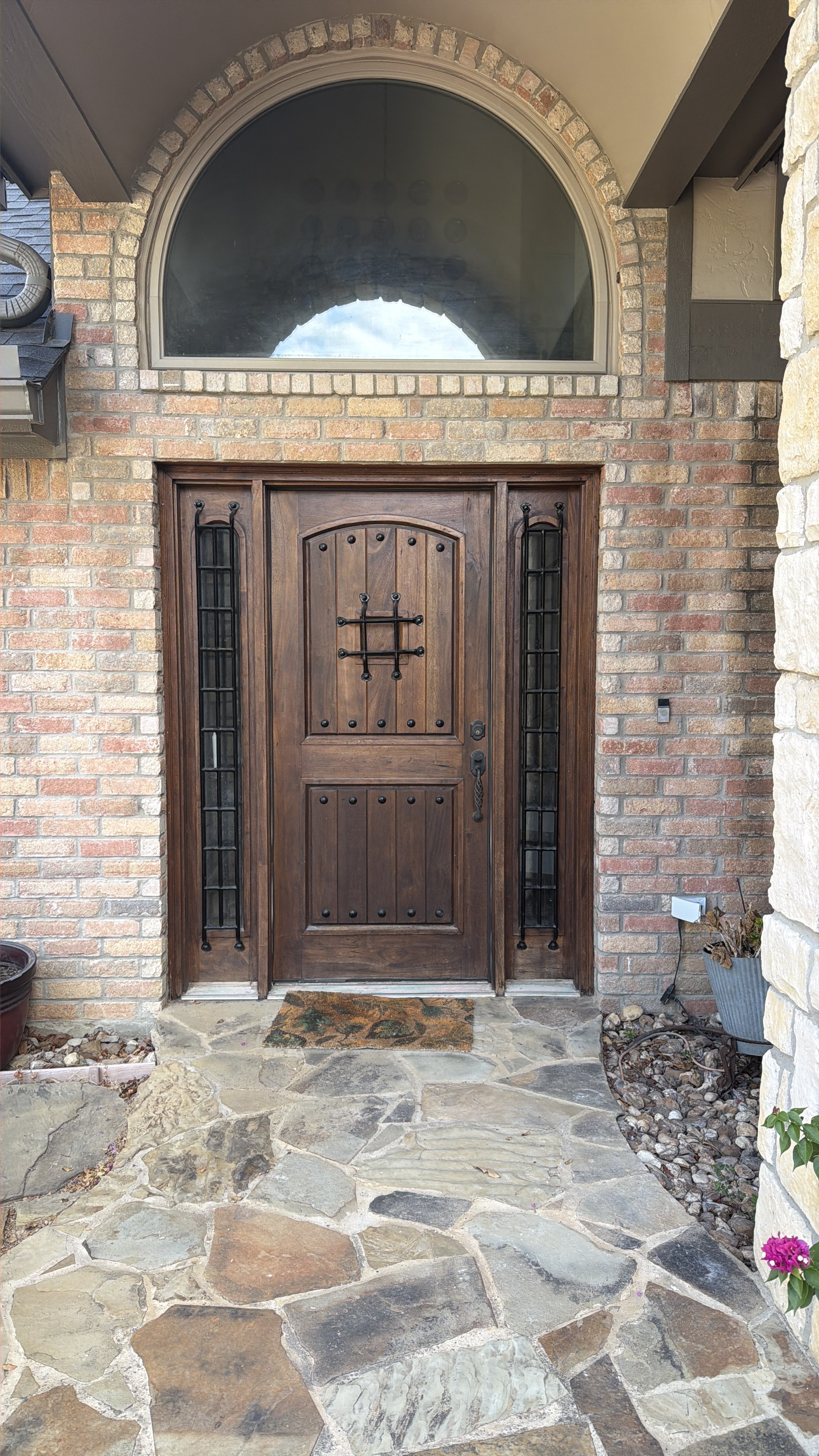 Finished wood entry door in a stone surround