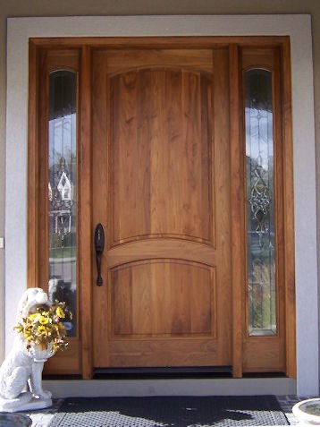 Finished natural wood front door with sidelights