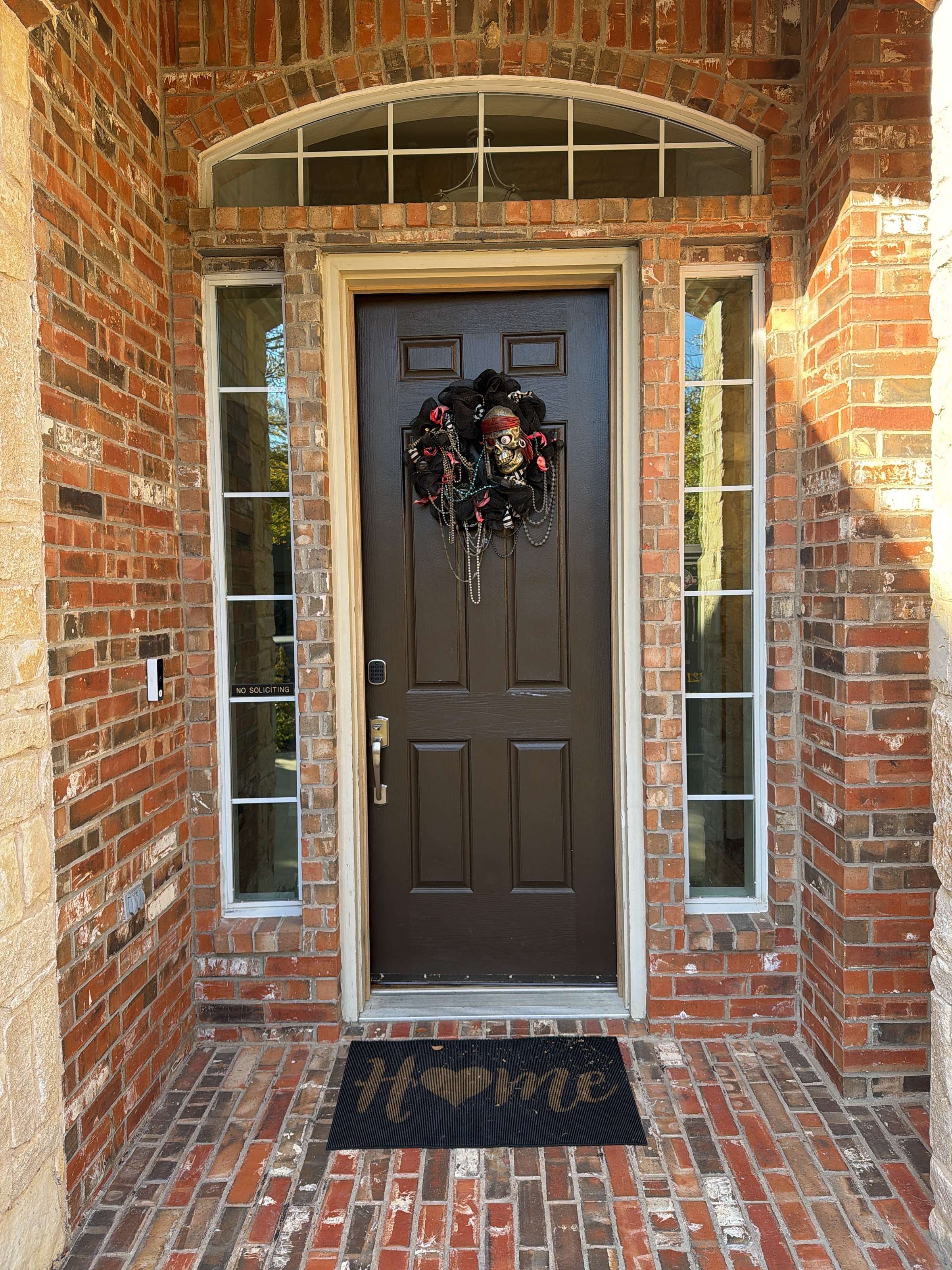 Finished dark front door with sidelights