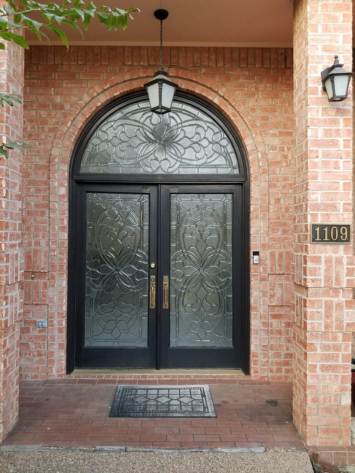 Finished arched black double entry doors