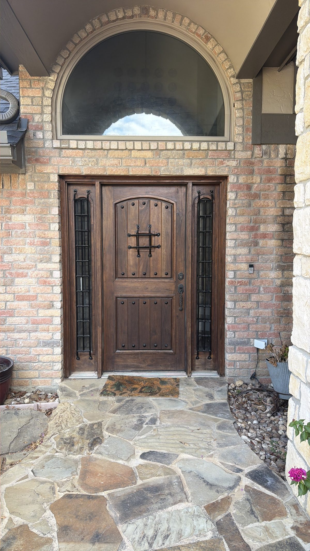 Finished wood entry door in a stone surround