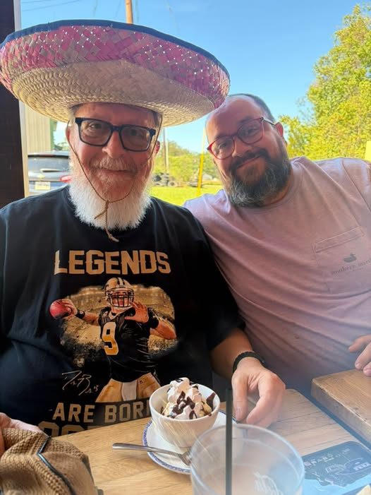 Danny and Derek smiling together at a restaurant