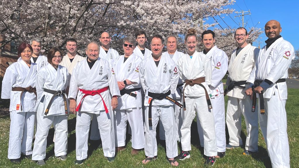 Virginia Dojo members practicing karate together outdoors in spring