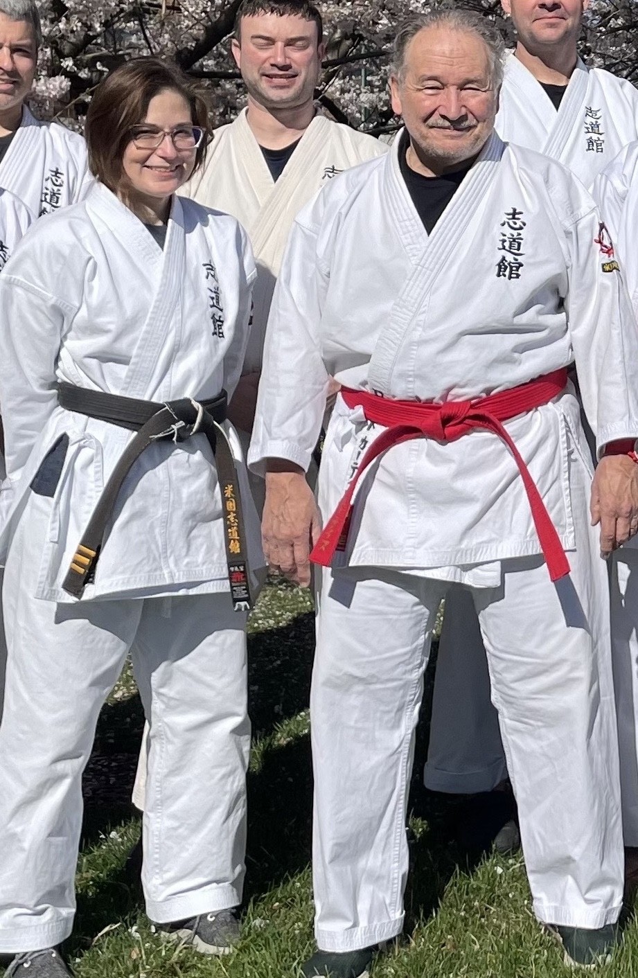 Roberto Curtis and Denise Coursey training under cherry blossoms