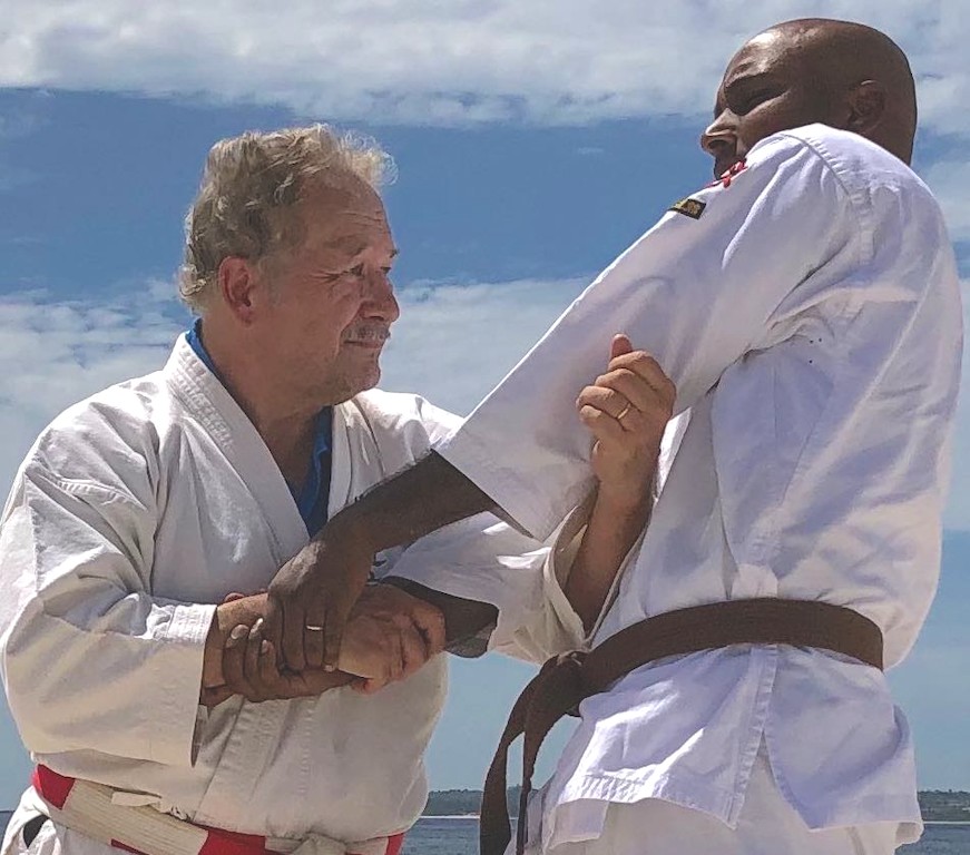 Roberto Curtis practicing a karate partner technique at Motobu Beach in Okinawa