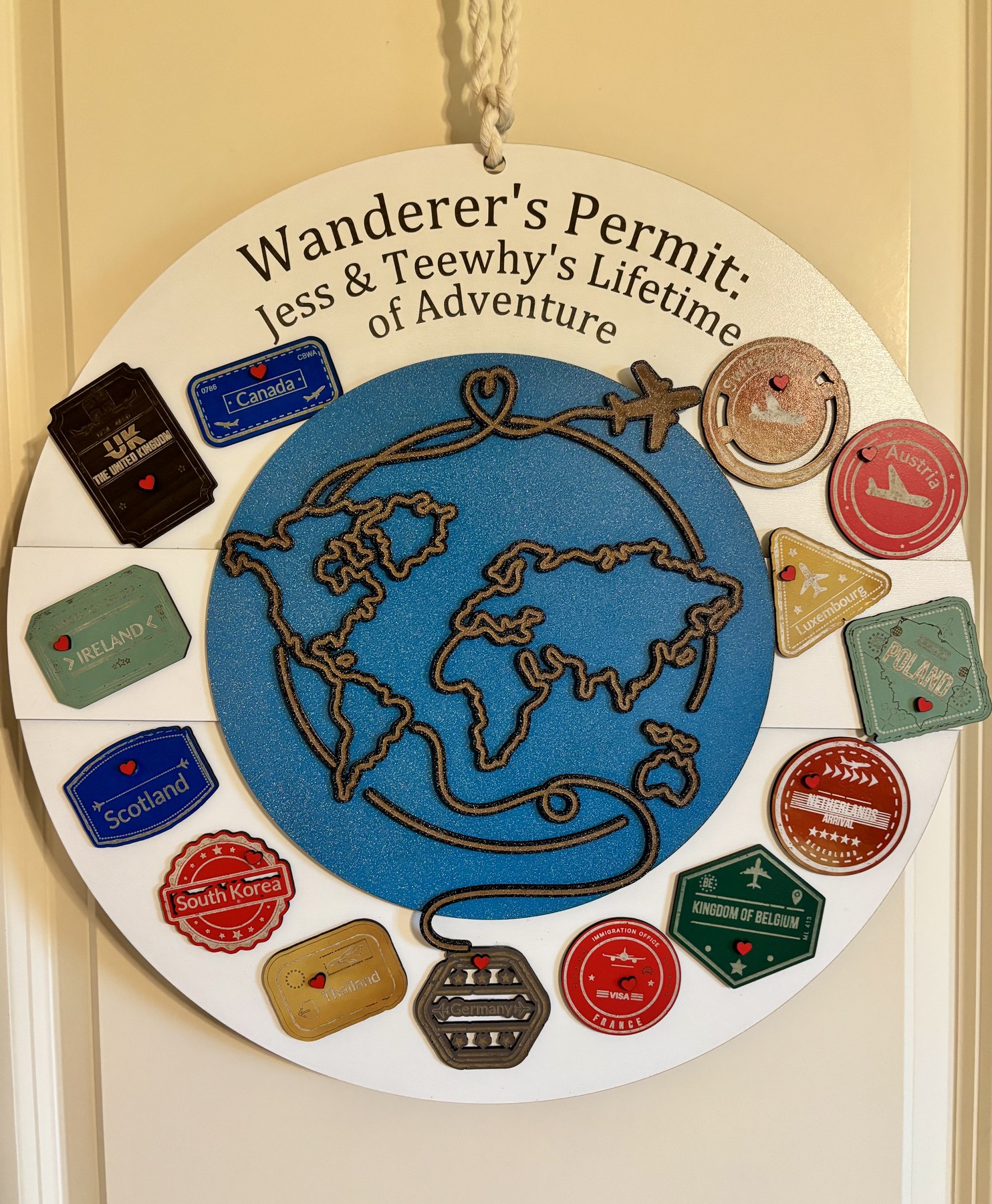 Round wooden adventure challenge tracker with travel badges