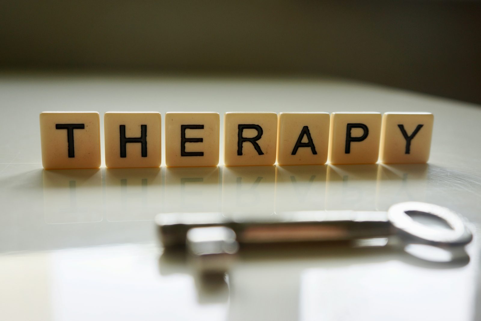 Letter tiles spelling THERAPY beside a key