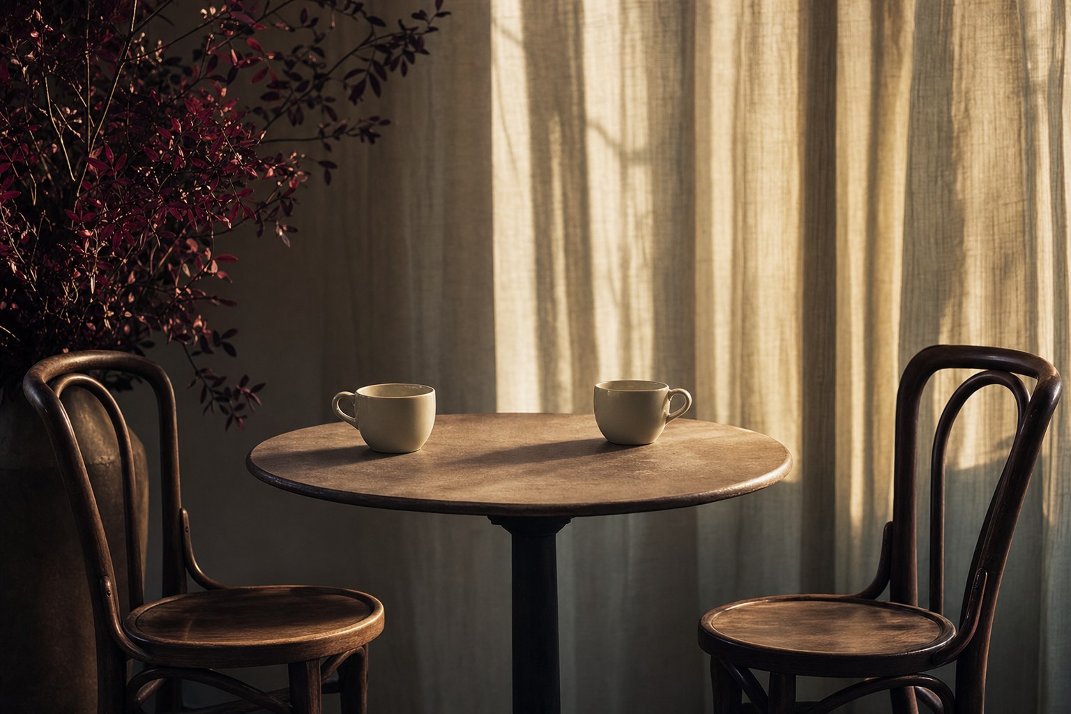 Two cups and empty chairs set for a respectful conversation