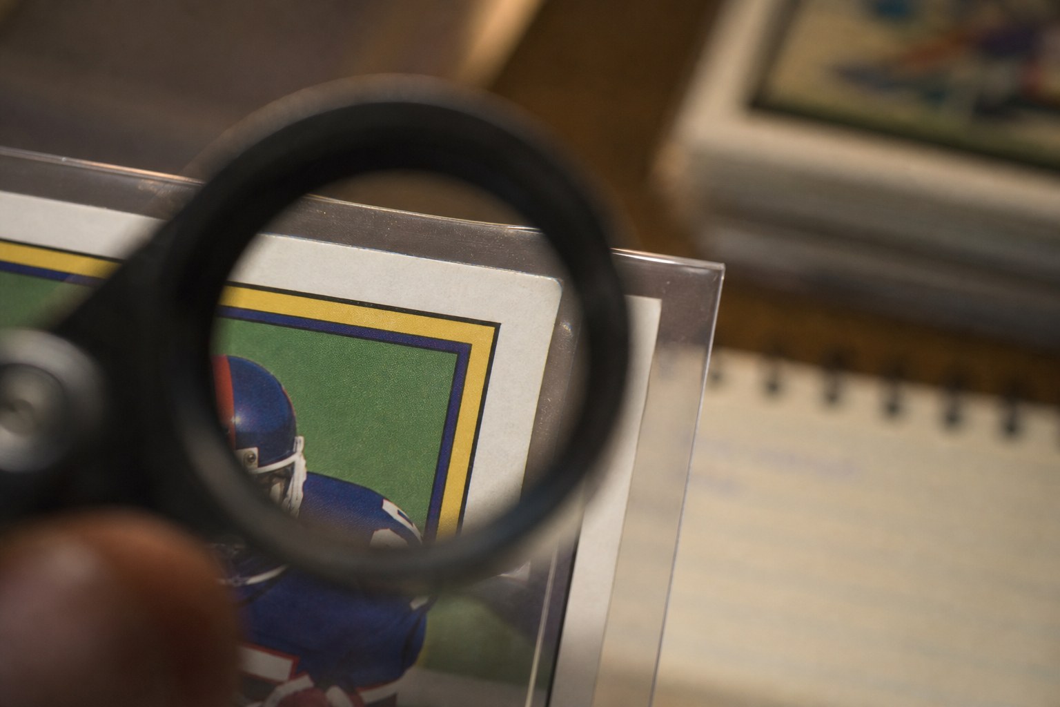 Close view of a football card corner through a jeweler loupe
