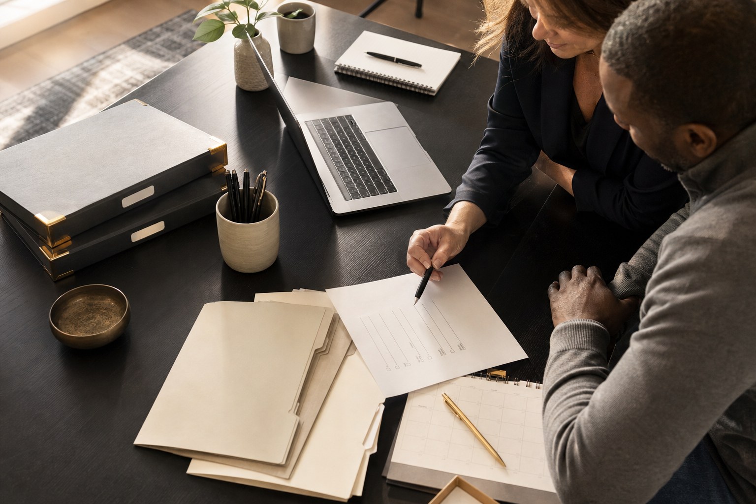 Two professionals organizing project materials and a task list