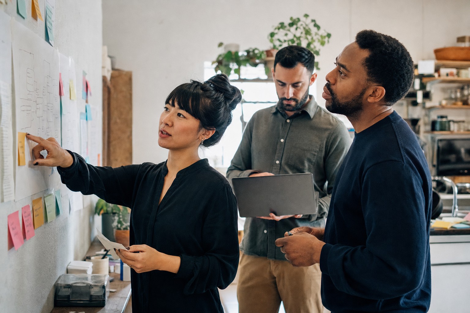 Small team organizing a business process together in a practical workspace