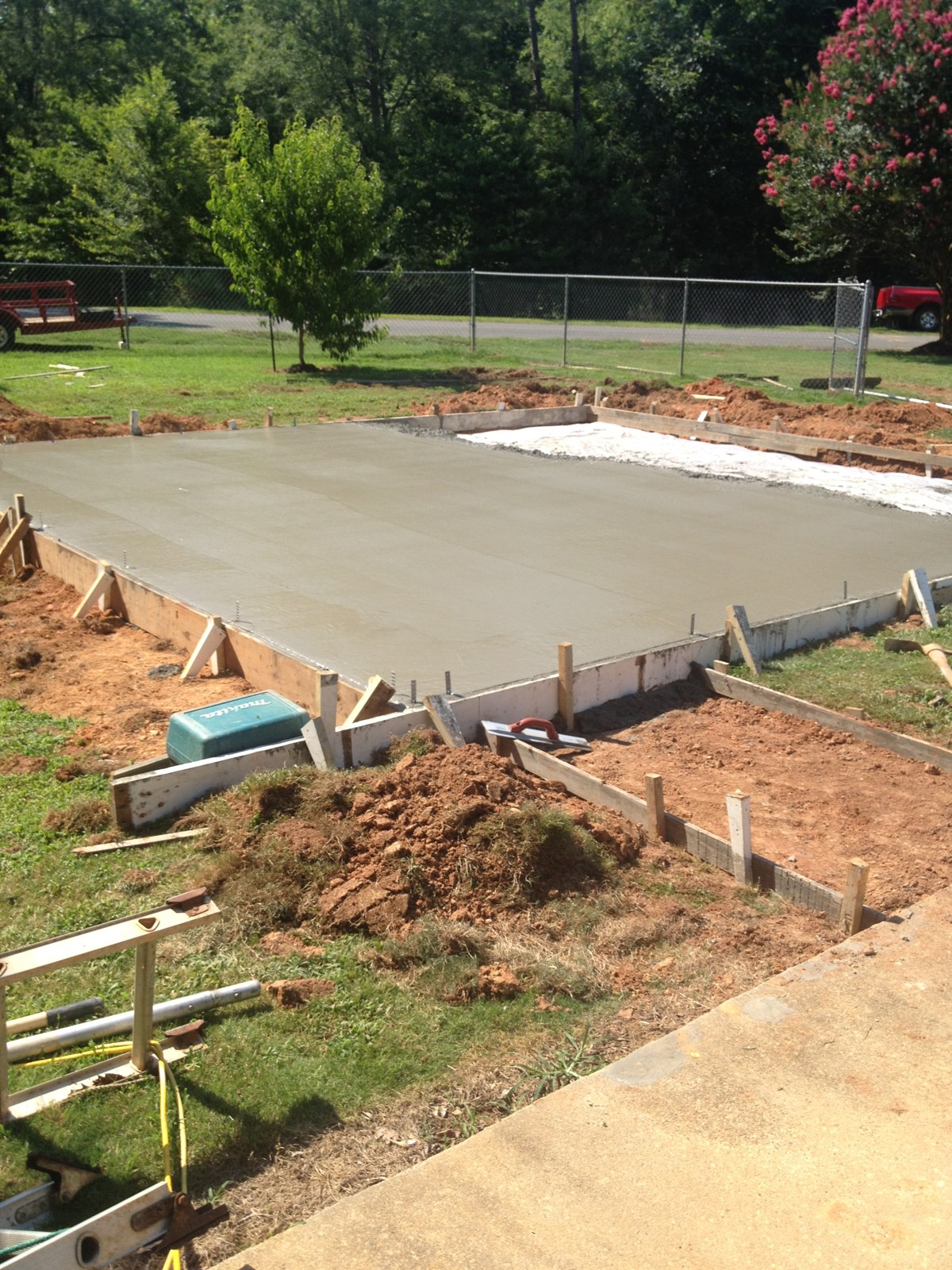 Monolithic garage foundation during concrete placement and finishing