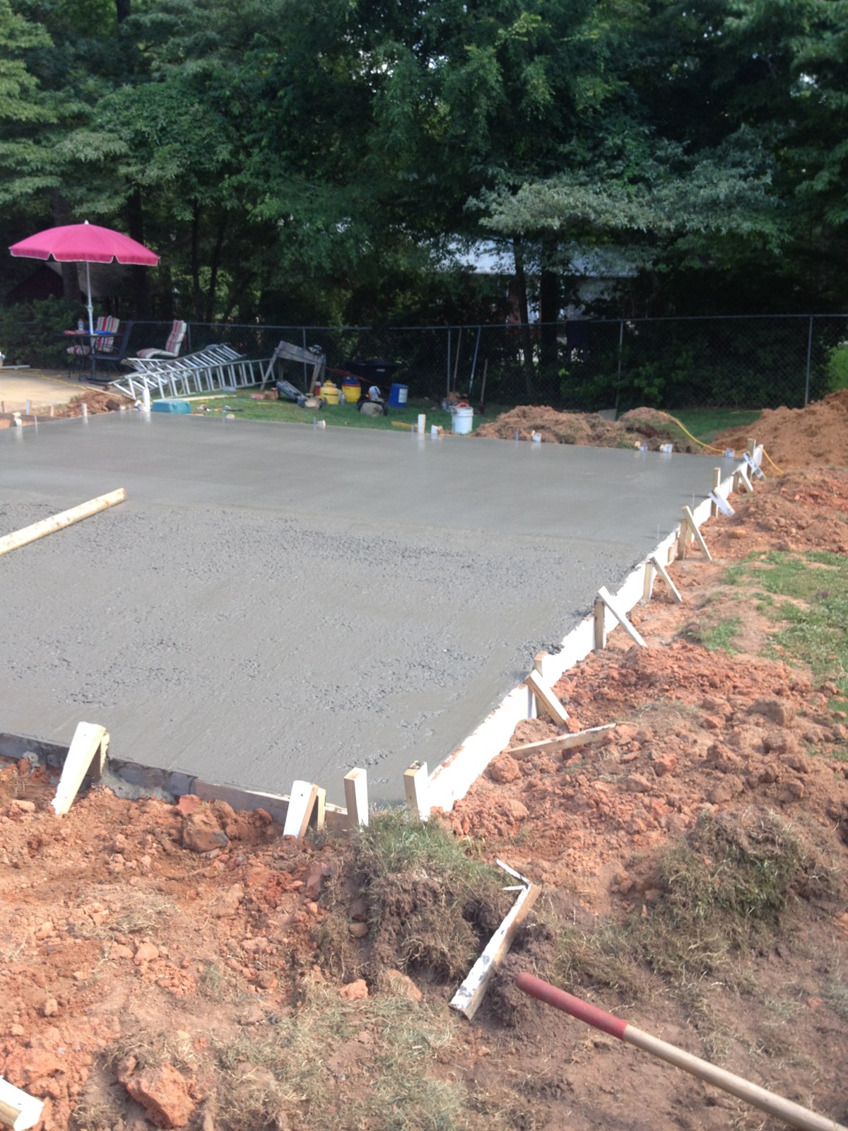 Monolithic garage foundation during concrete placement and finishing