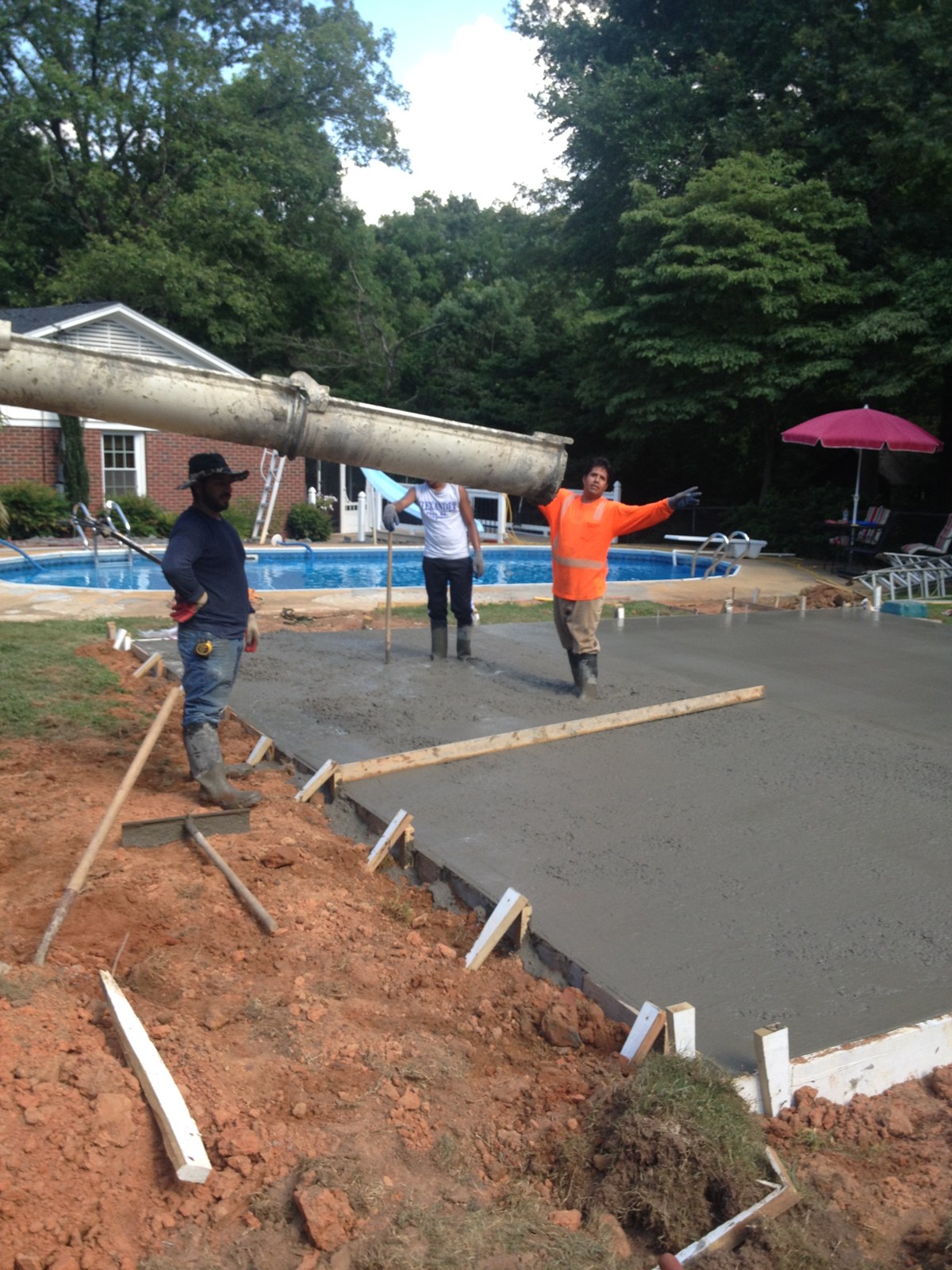 Monolithic garage foundation during concrete placement and finishing
