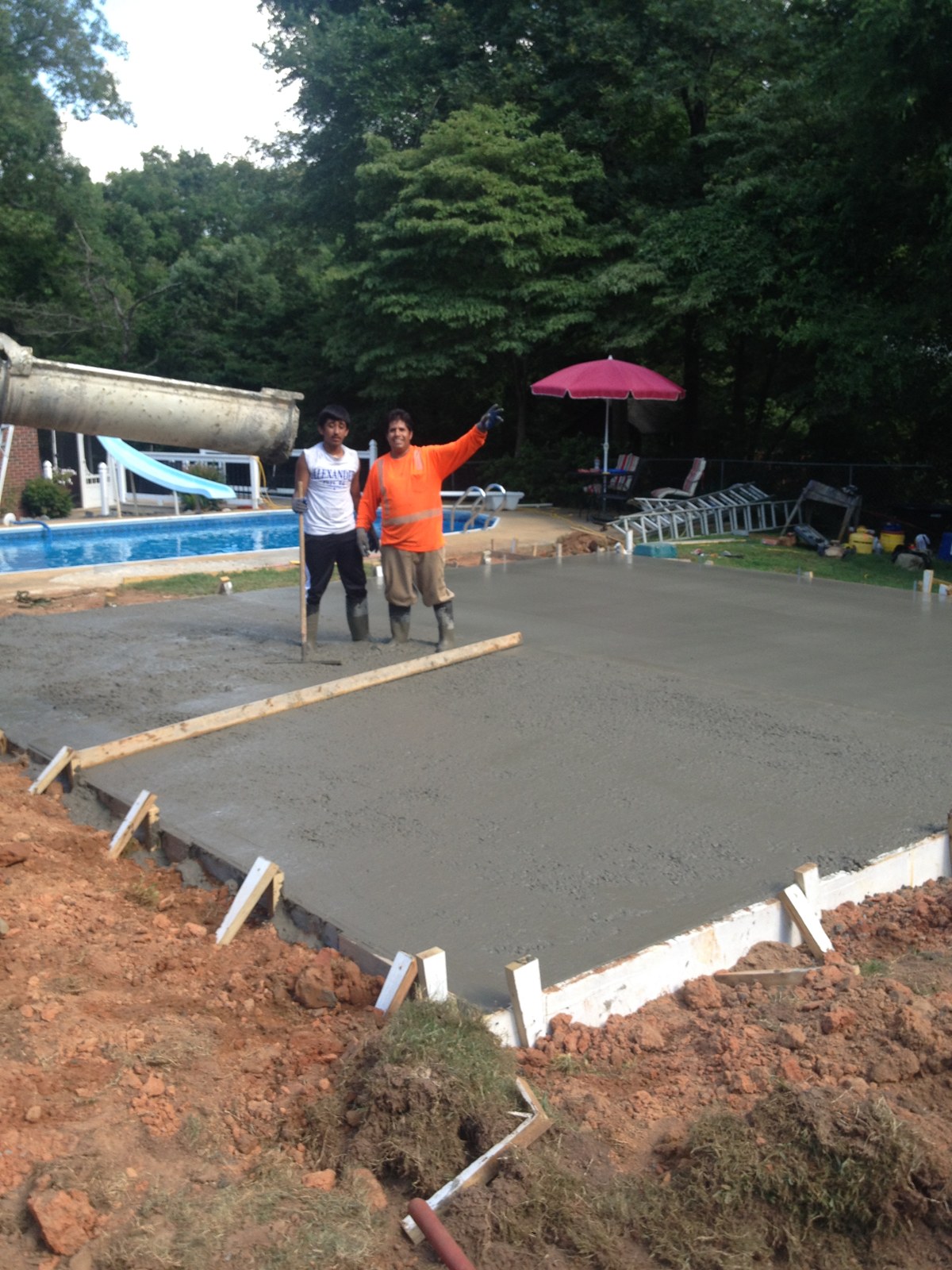 Monolithic garage foundation during concrete placement and finishing