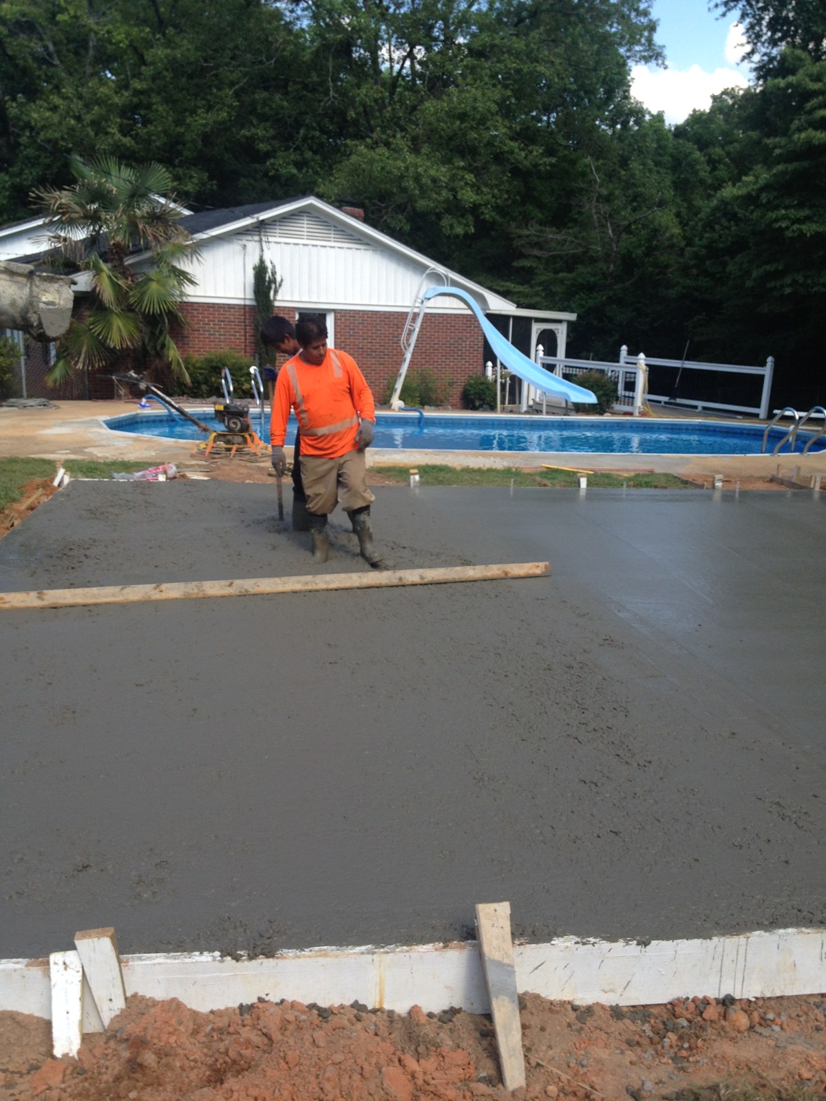 Monolithic garage foundation during concrete placement and finishing
