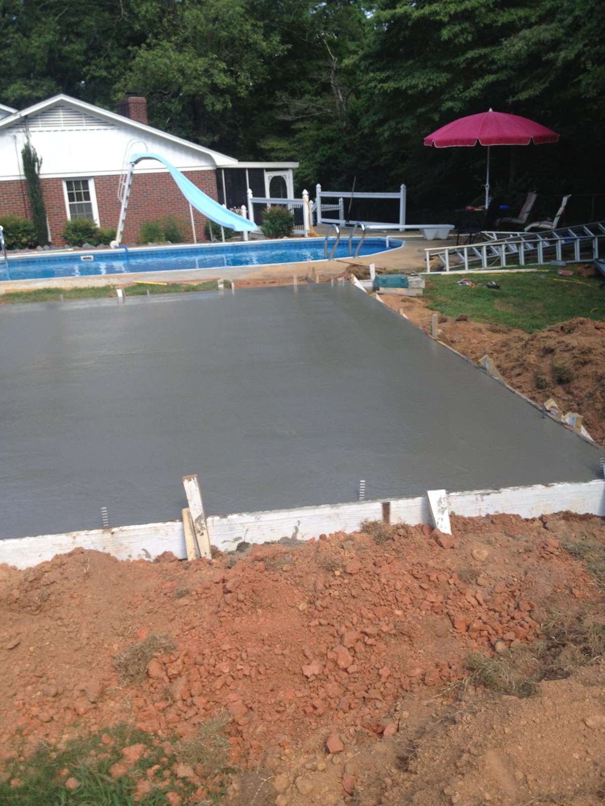 Monolithic garage foundation during concrete placement and finishing