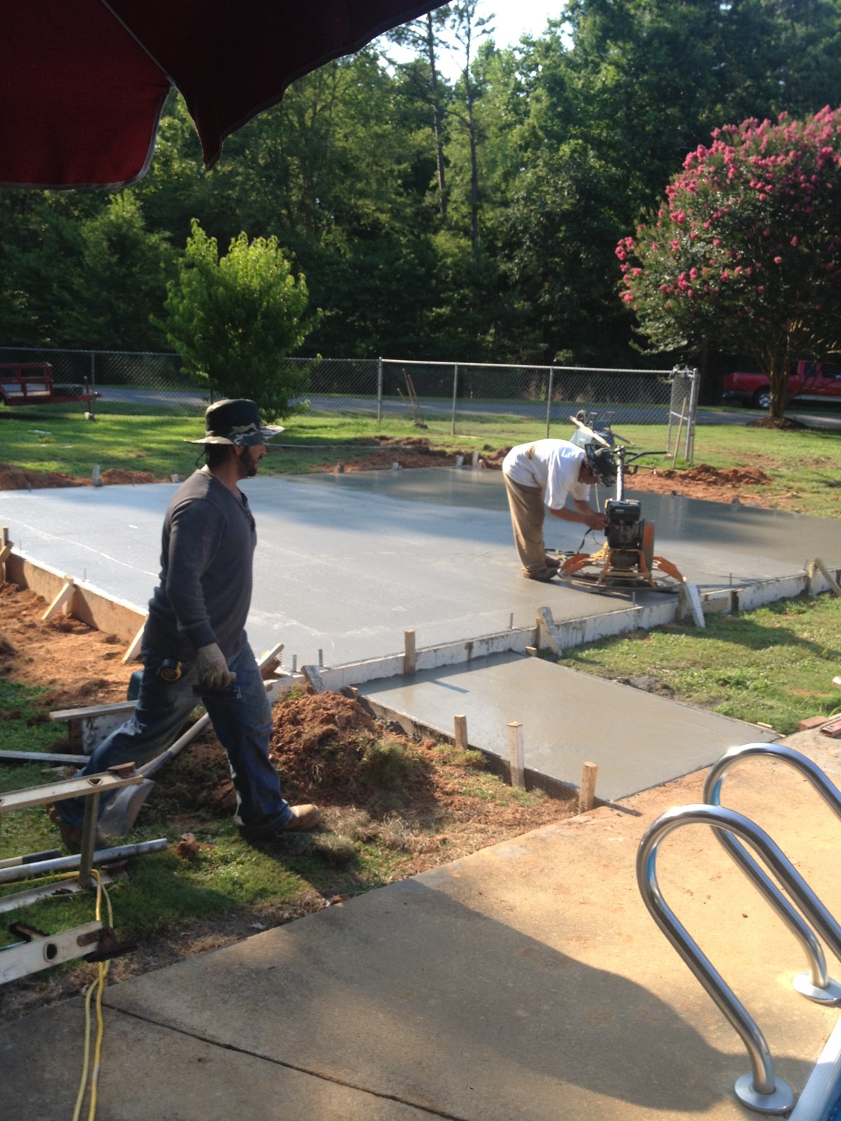 Monolithic garage foundation during concrete placement and finishing