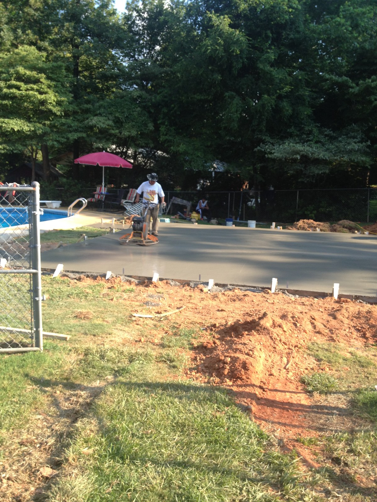 Monolithic garage foundation during concrete placement and finishing