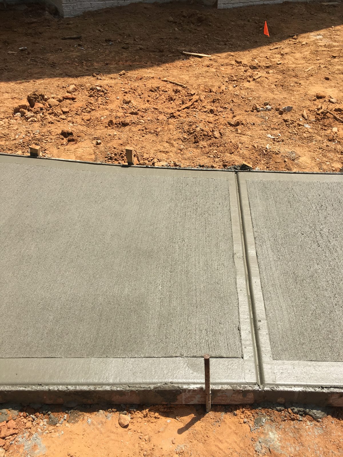 Close view of a finished concrete walkway and its joint detail