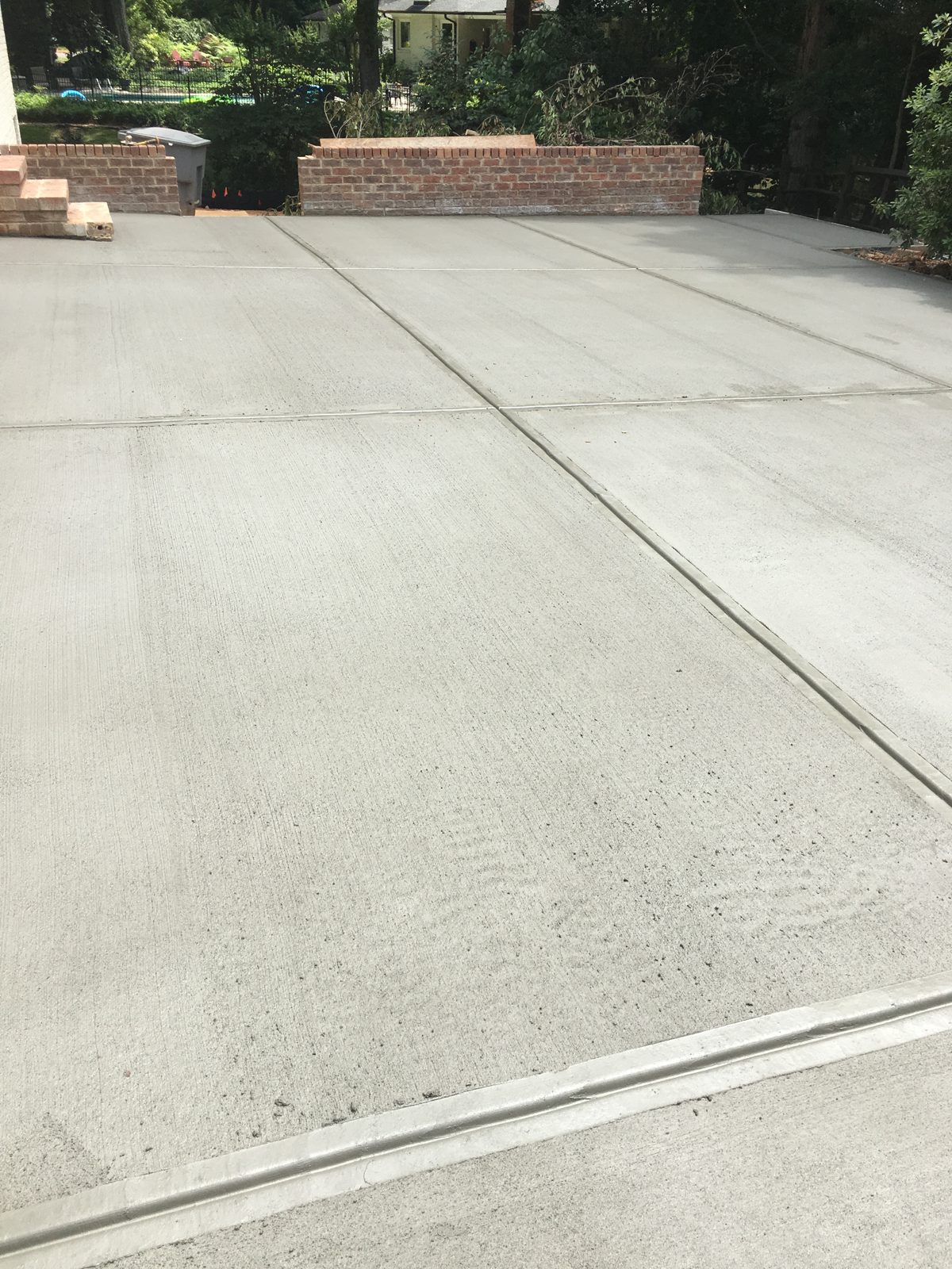 Wide concrete driveway with neatly spaced control joints