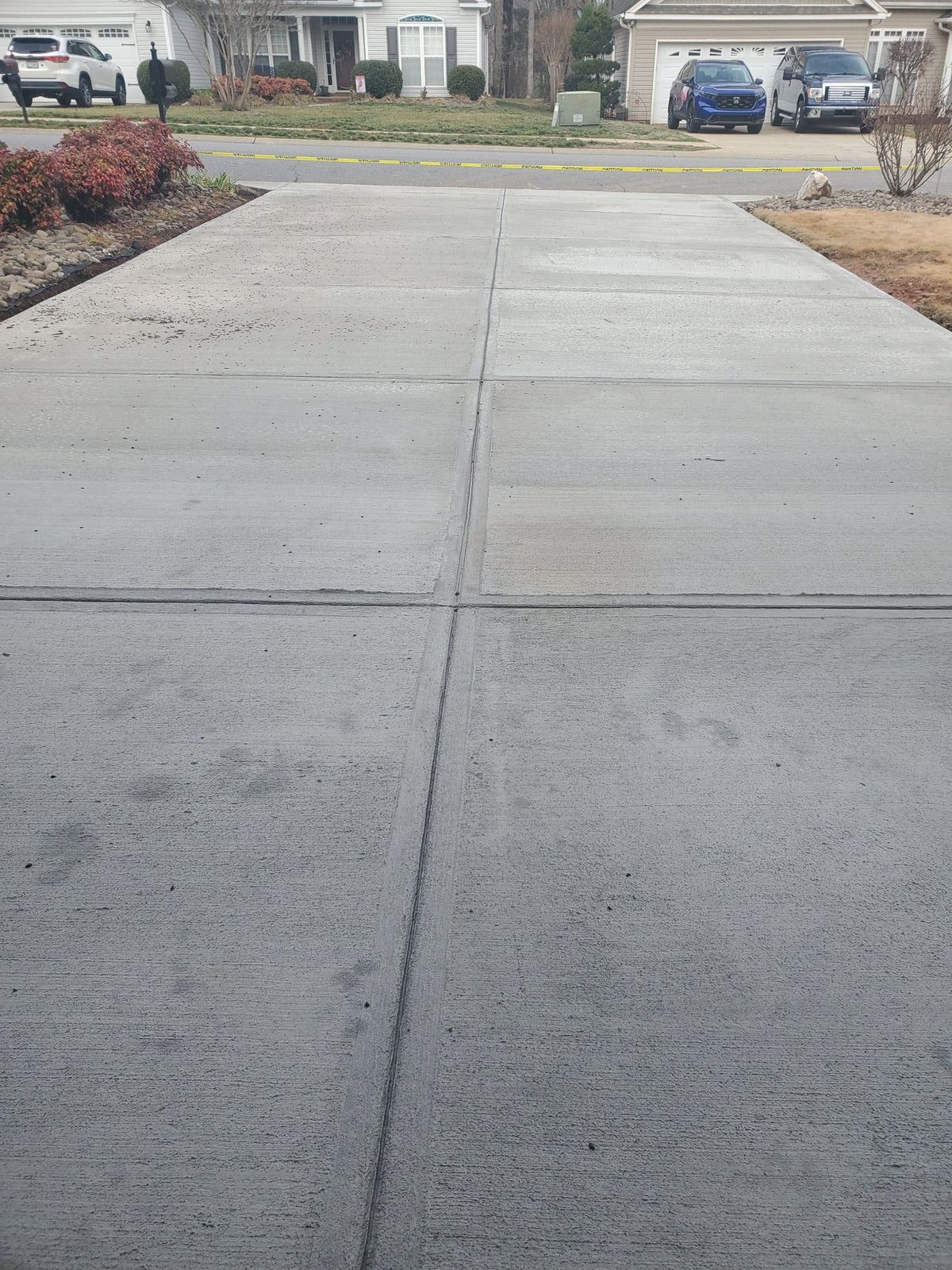 Finished driveway showing a broom-textured surface and neat joints