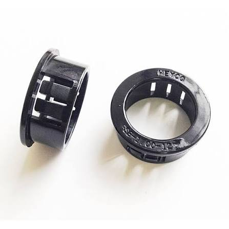 Two black snap bushings for protecting wire and cable at panel openings