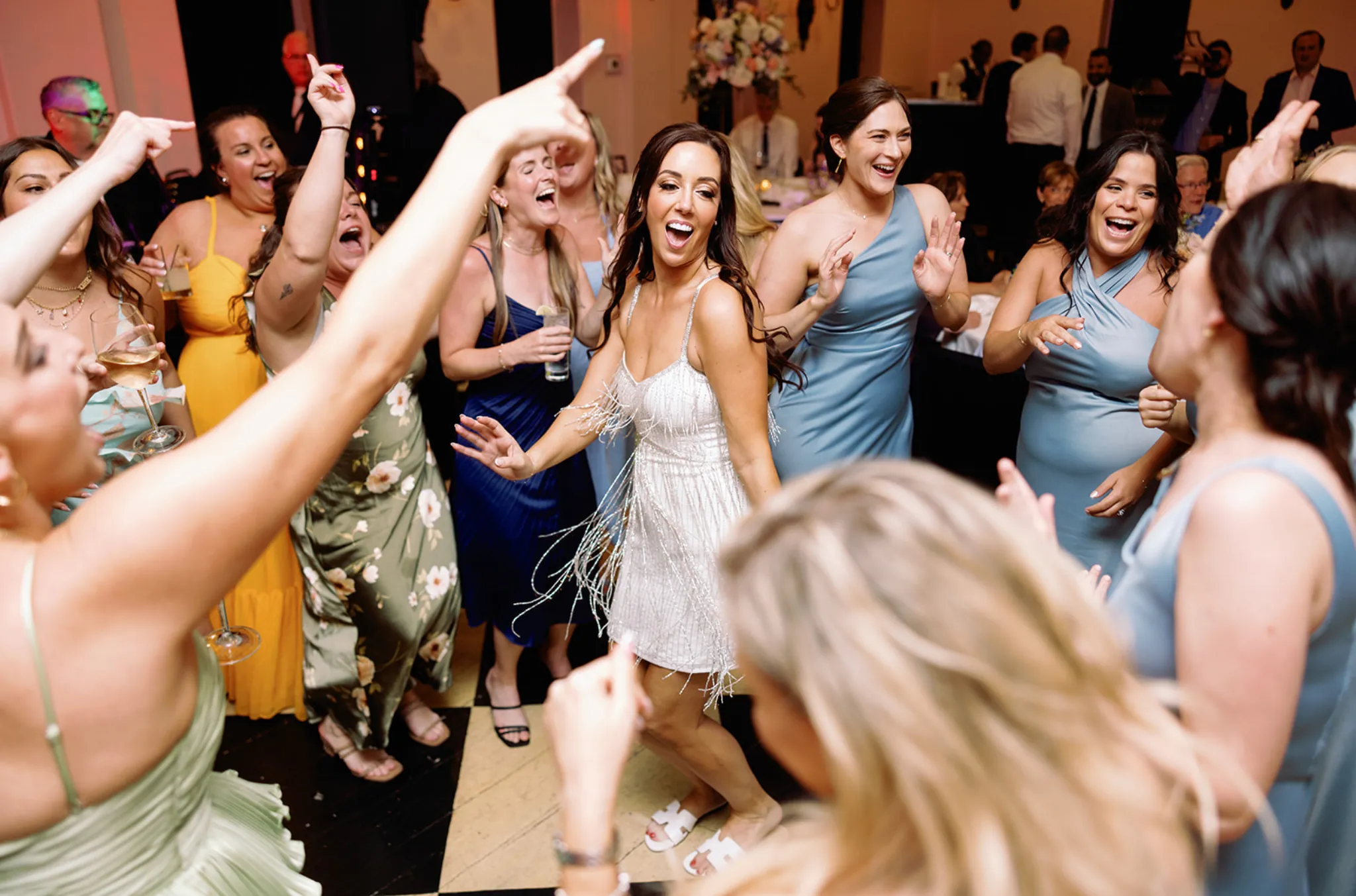 Wedding guests dancing around the bride at a reception