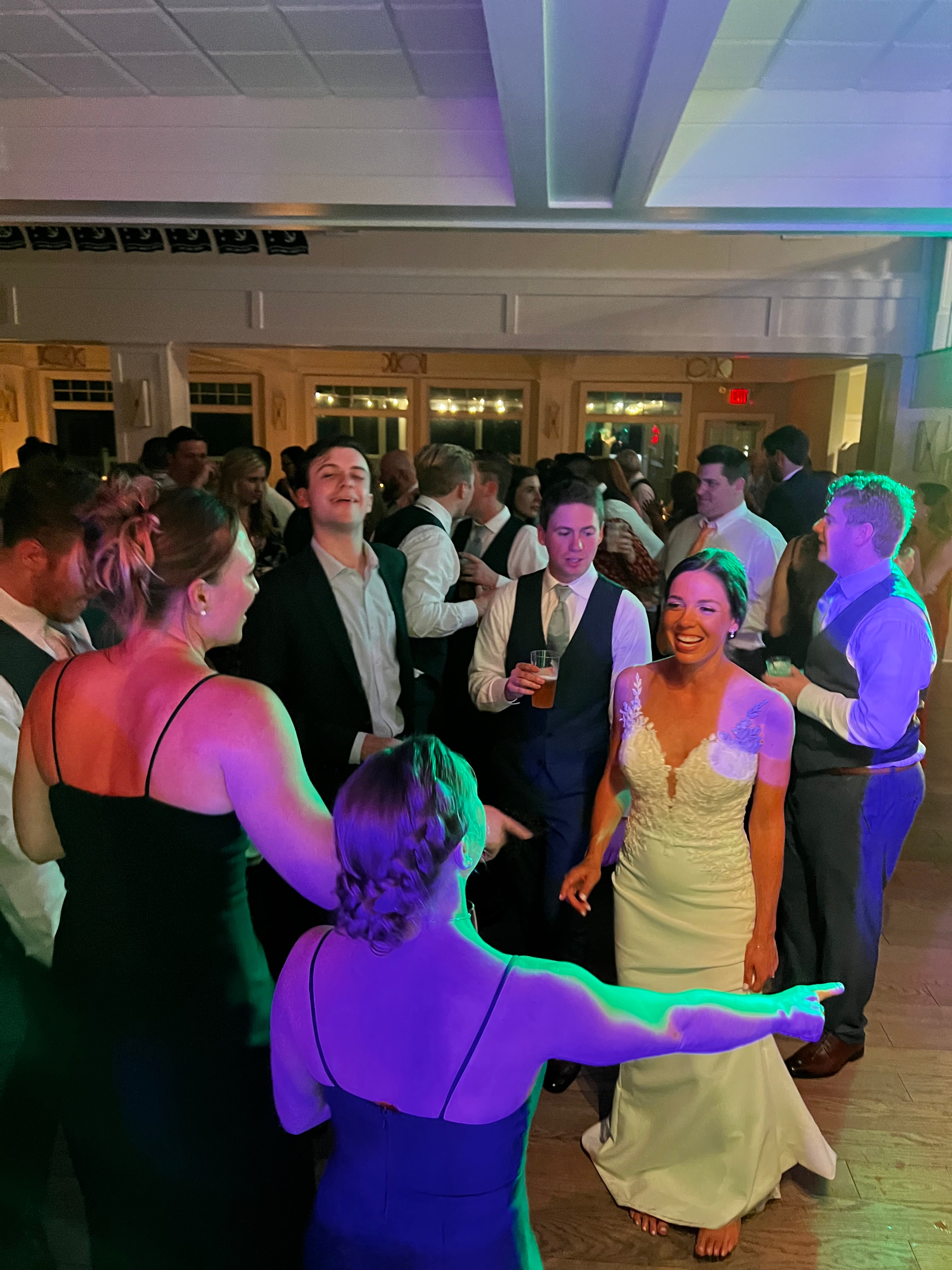 Wedding guests dancing around the bride at a reception