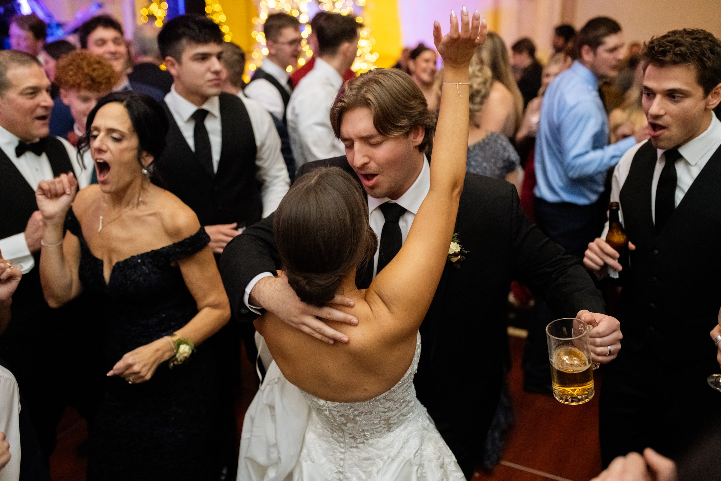 Wedding guests dancing together at a lively reception