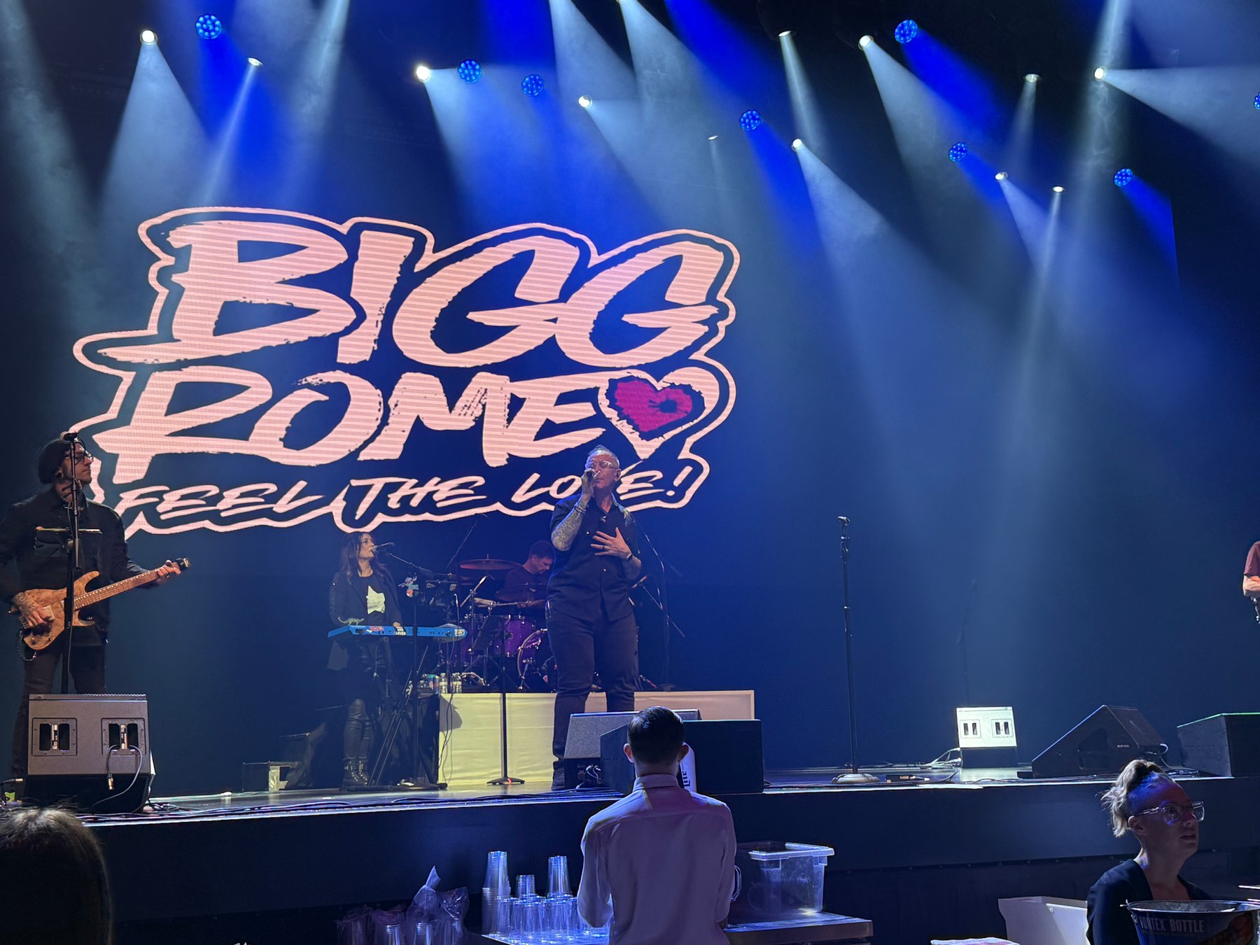 Bigg Romeo performing under blue stage lights