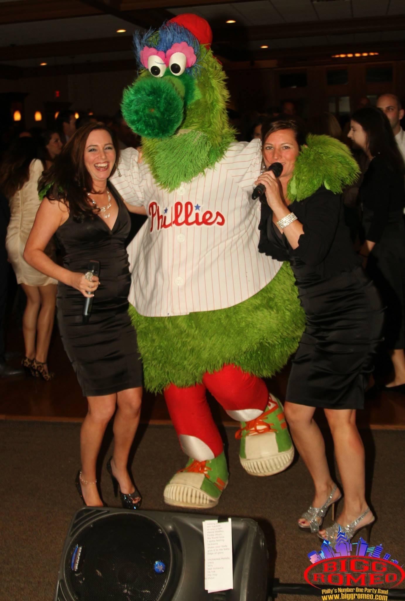 Bigg Romeo singers with the Phillie Phanatic at a celebration