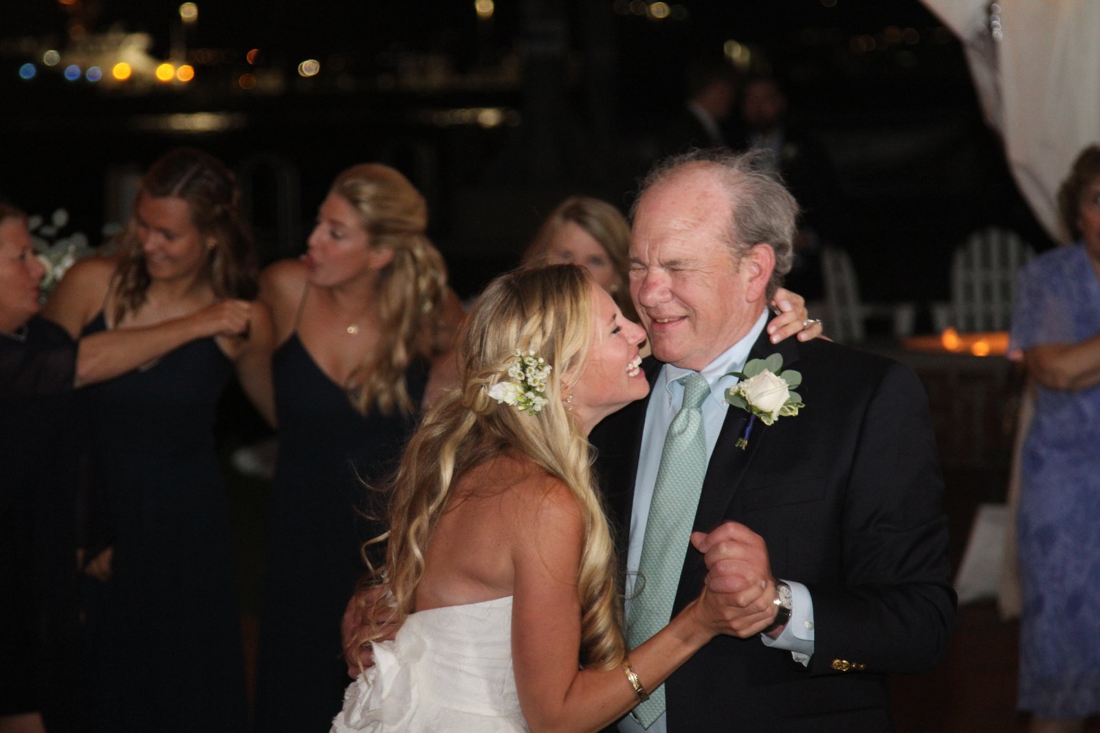 A bride sharing a dance with a family member at her wedding reception